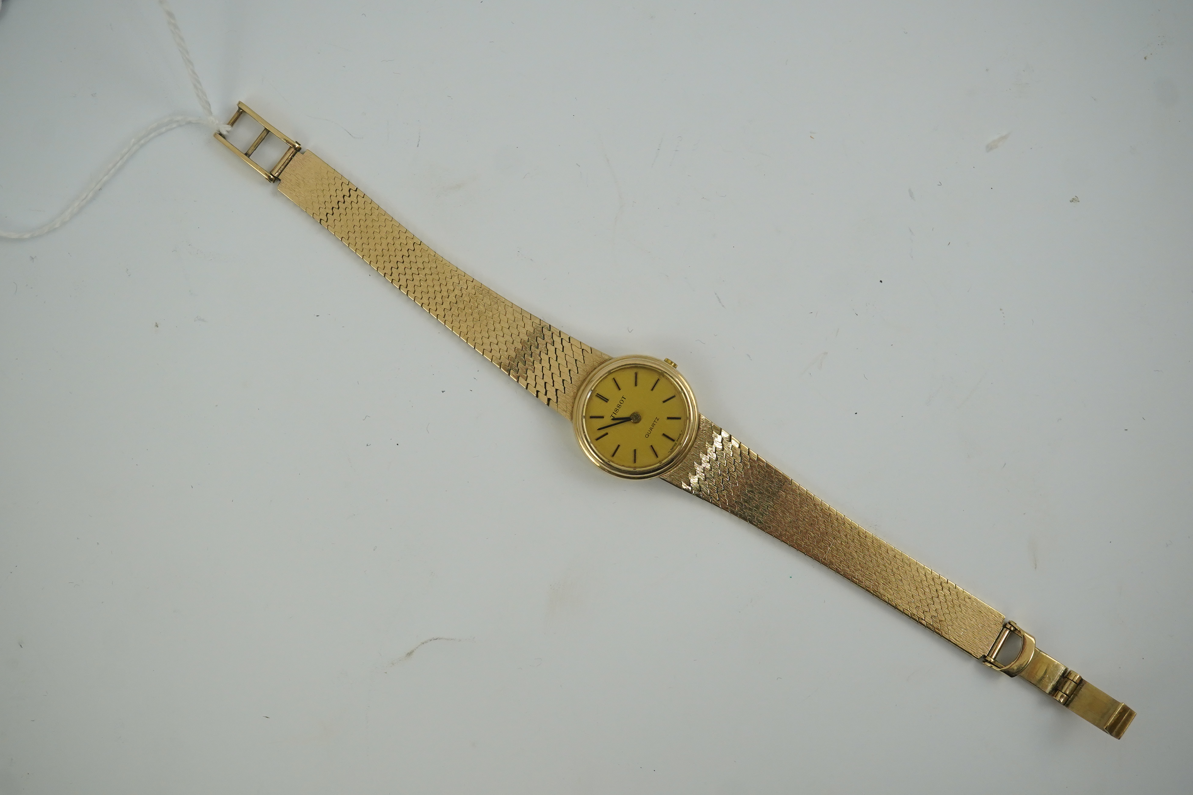 A lady's early 1980's 9ct gold Tissot quartz wrist watch with textured 9ct gold associated bracelet